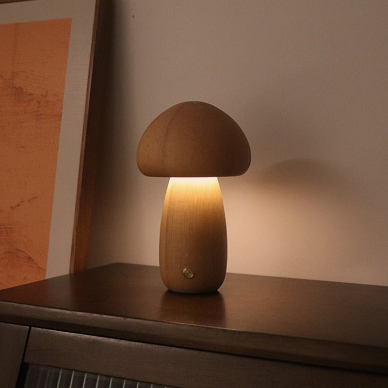 Wooden mushroom lamp on a wooden surface with a warm glow